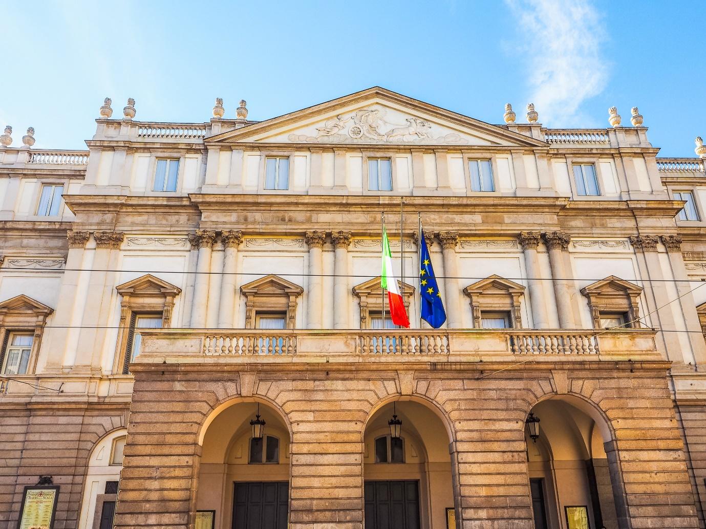 A building with flags on the balcony

Description automatically generated