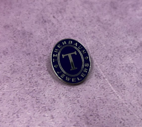 a shiny nickel lapel pin with blue enamel color 
