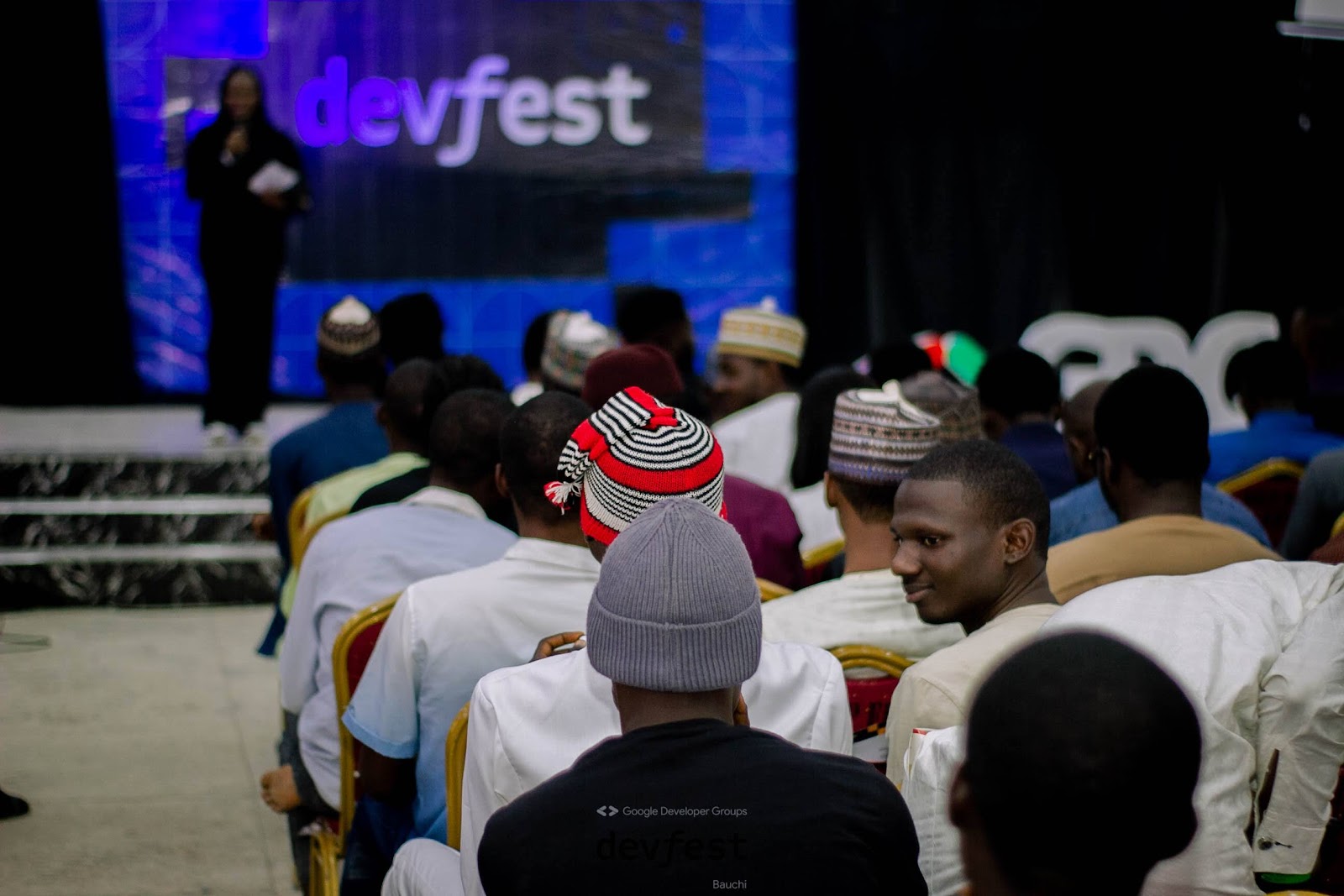 A cross-section of attendees sitted and Moturayo on stage.