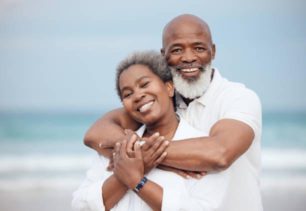 Shot of a mature couple spending time at the beach Do we ever question it? Nah black lovers stock pictures, royalty-free photos & images