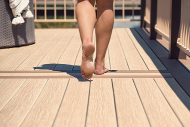 homeowner walking on composite deck during the summer custom built michigan