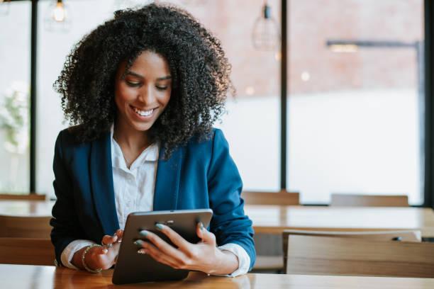 young businesswoman using digital tablet - african lady stock pictures, royalty-free photos & images