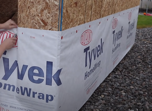 Tyvek HomeWrap continue unrolling, align the material with your markings and nail it in place