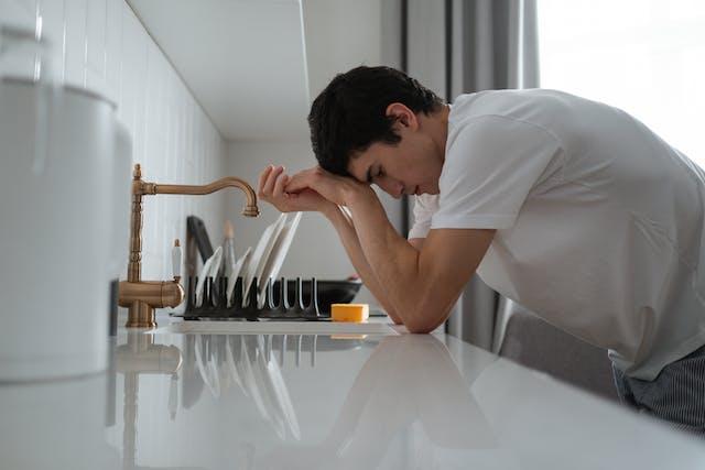 a man experiencing a major drain clog from grease.