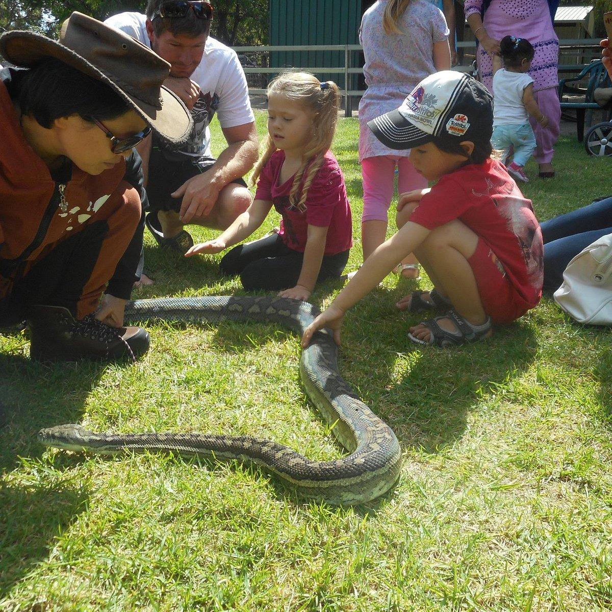 kids holding the snake