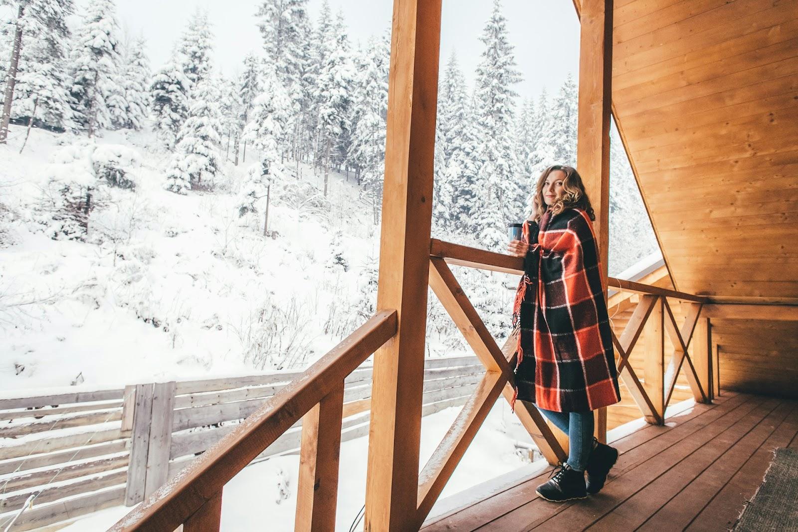 a woman standing on a chalet porch