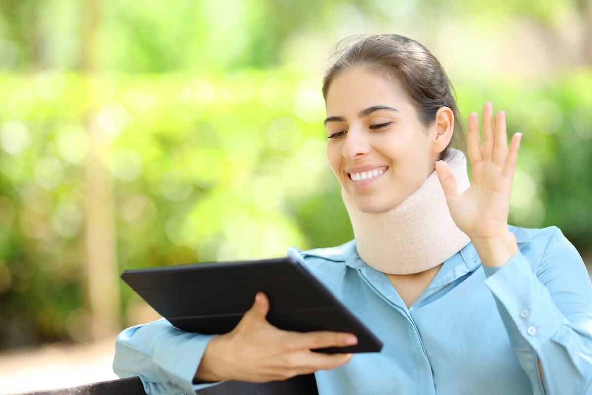 Injured woman using a tablet for a video call