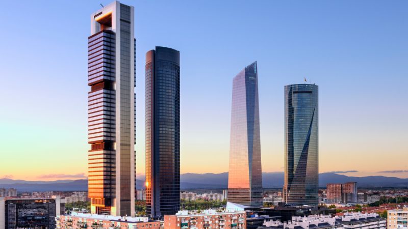 Barcelona vs Madrid Living - Sunset view of Madrid's four skyscrapers at the Cuatro Torres Business Area.