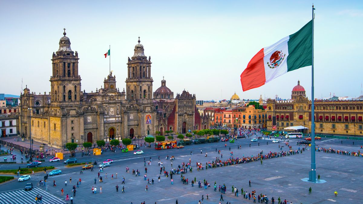 Mexico City Metropolitan Cathedral and the Mexican flag.