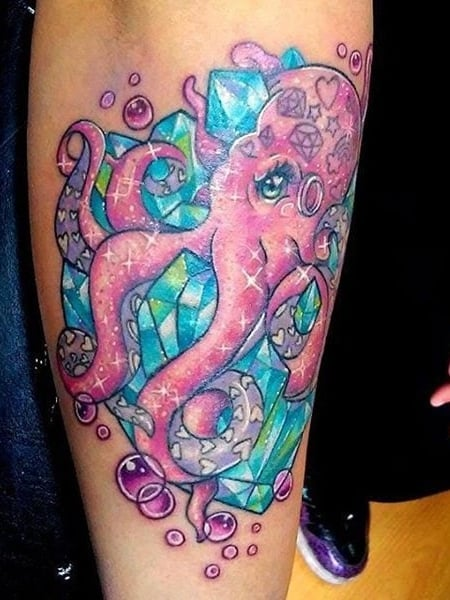 Picture a colorful tat design of the octopus on the arm of a lady