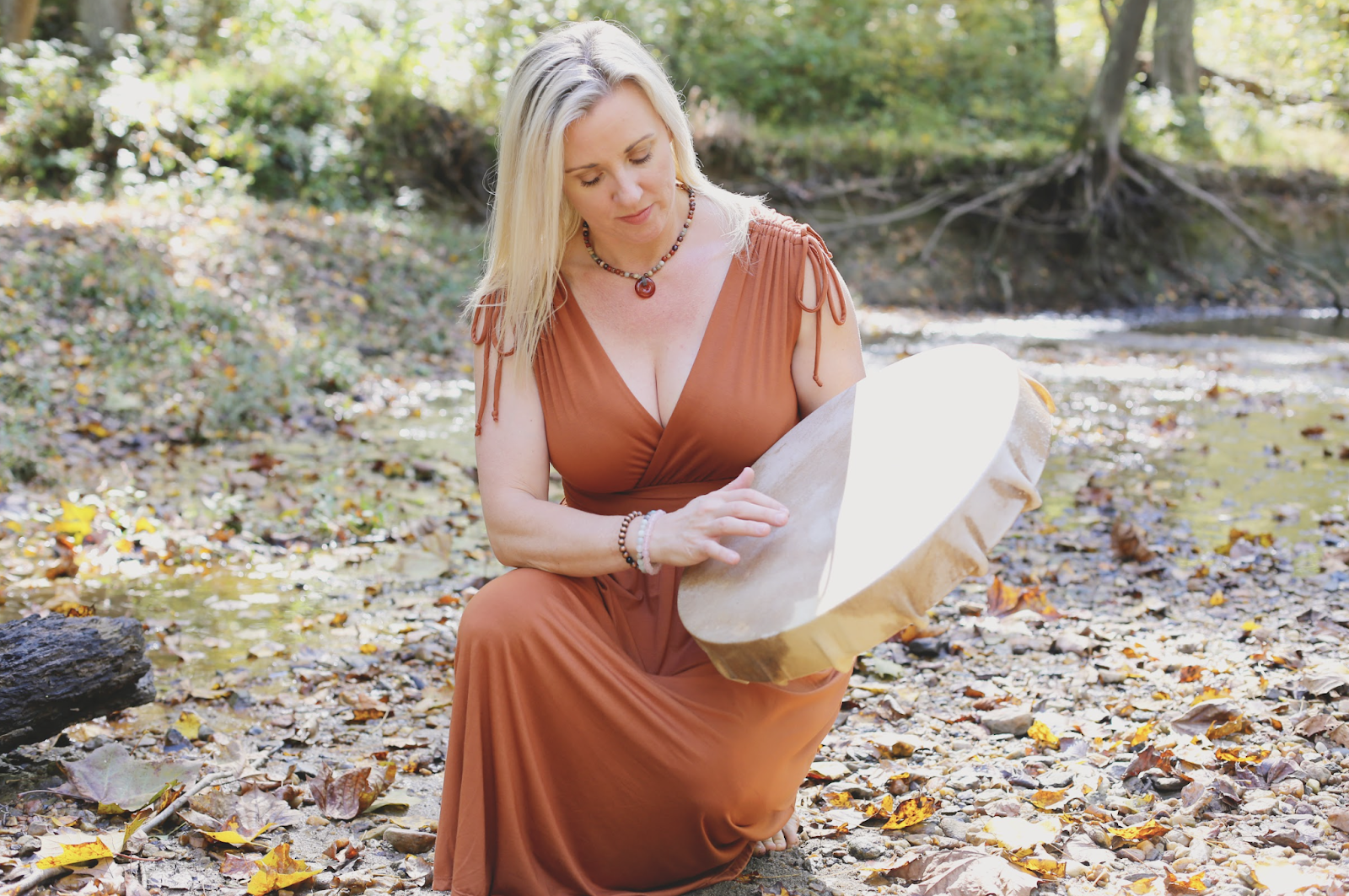 Spiritual counselor beating a drum during an experiential healing session