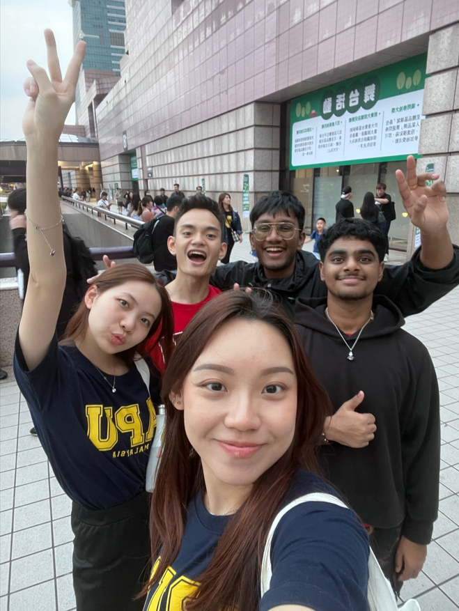 A group of people posing for a selfie

Description automatically generated