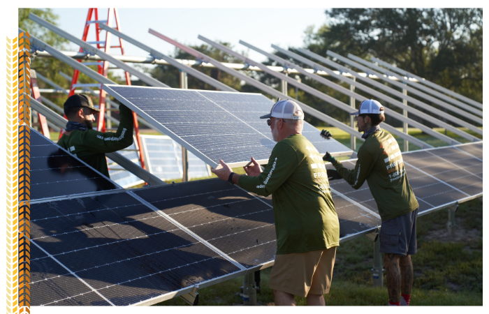 3 men helping each other installing solar panels