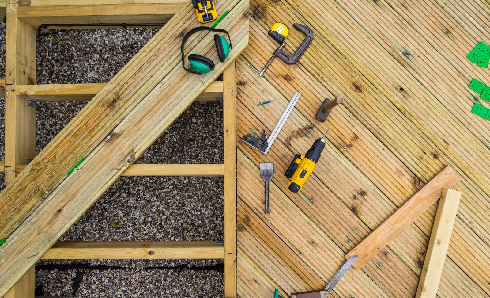 View from above of a wooden deck with various tools laying atop.