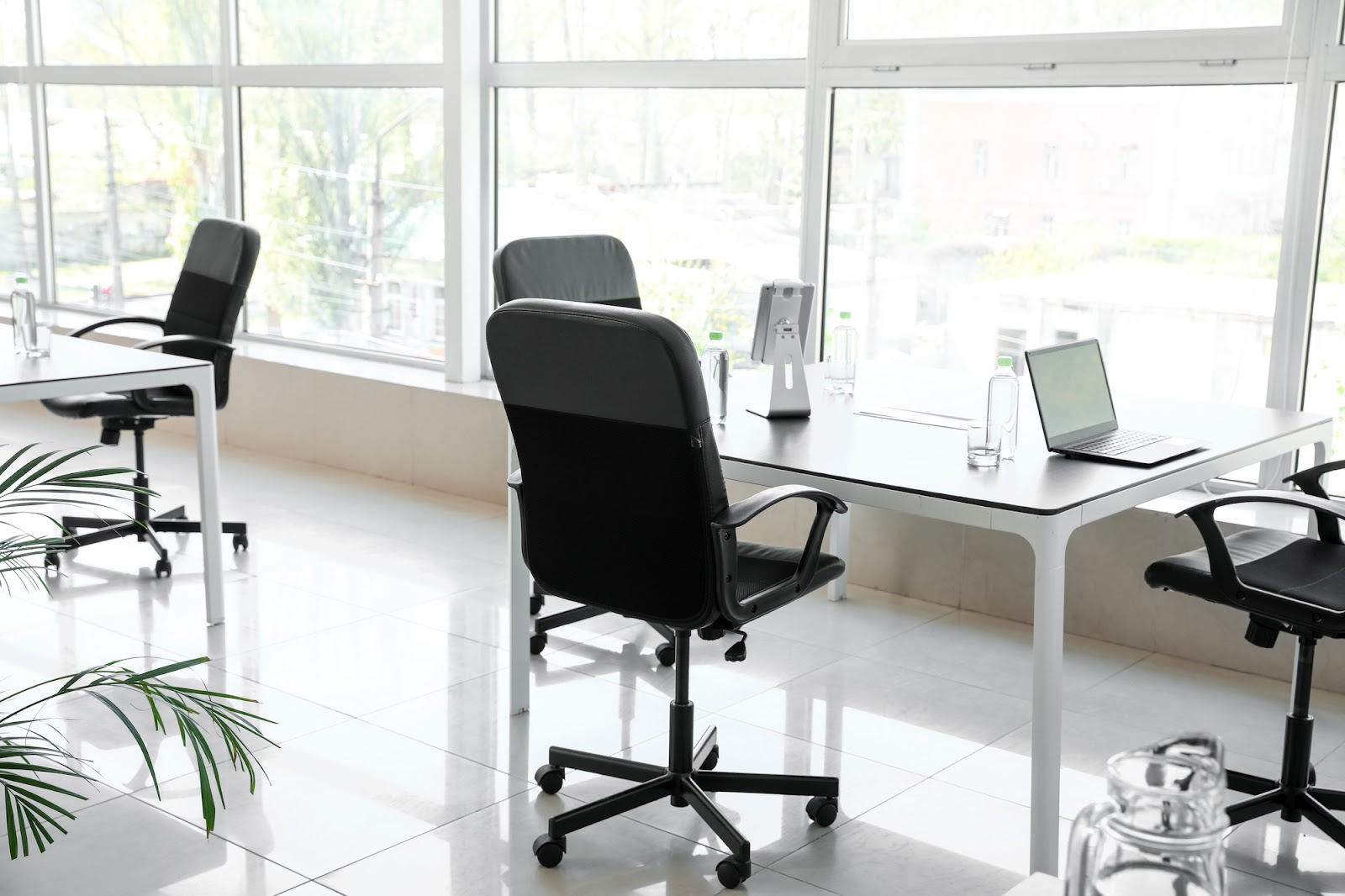 Modern office work space with desks and comfortable swivel chairs