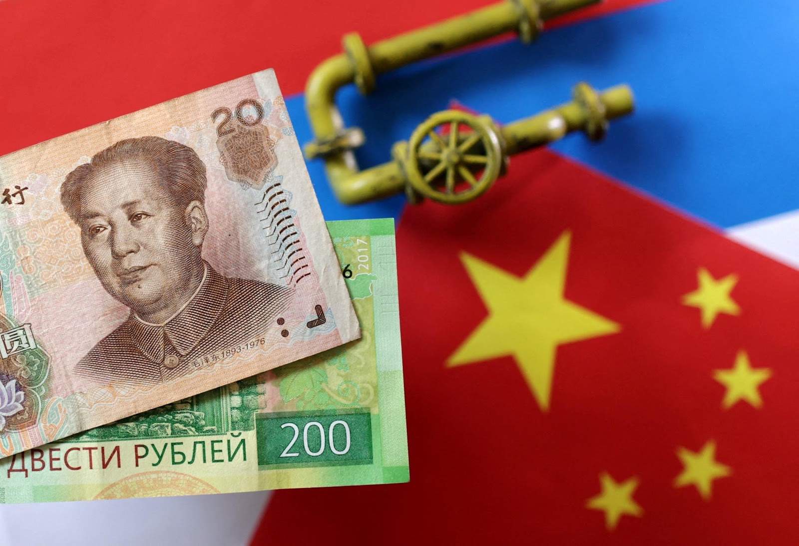 Illustration shows model of natural gas pipeline, Russian and Chinese flags and Yuan and Rouble banknotes