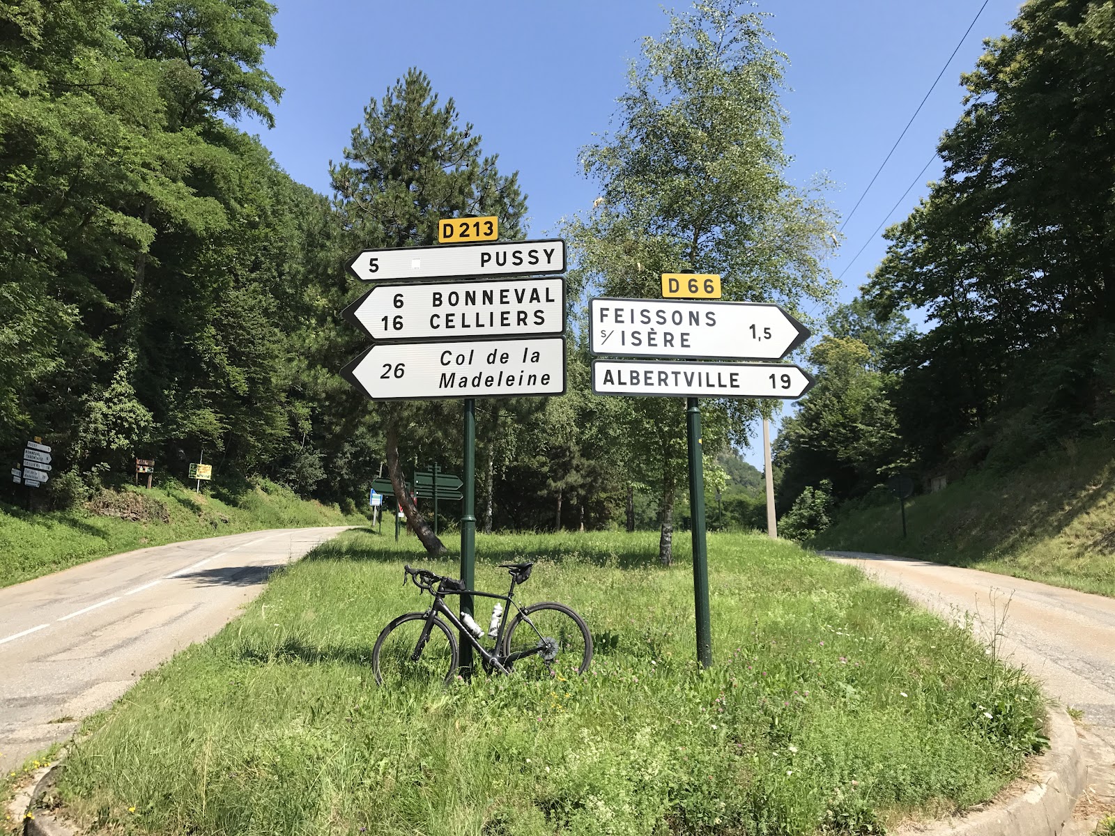 Bicycle ride of Col de Madeleine from La Léchère - start with roadway sign and bike
