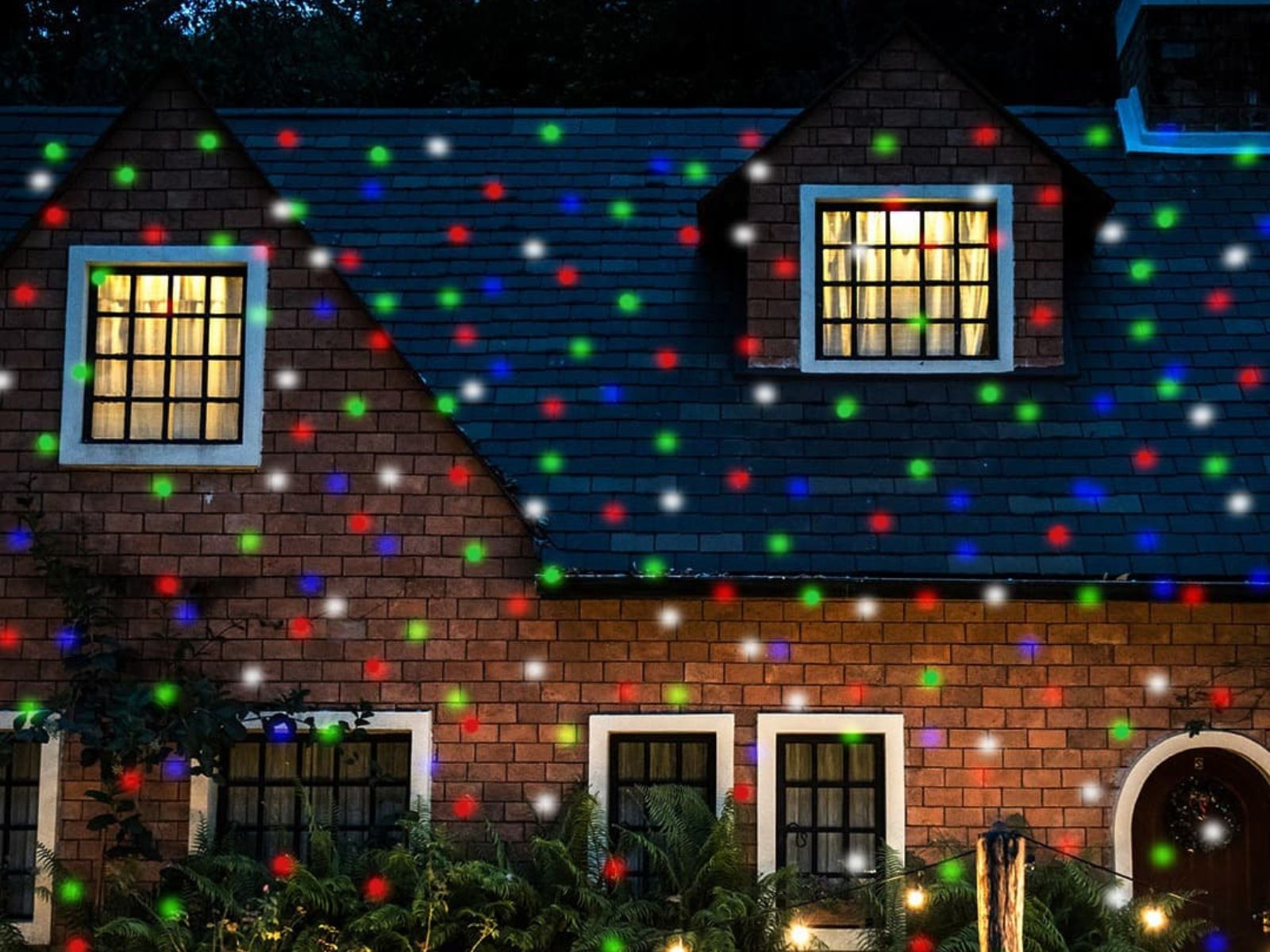 Star projector lighting on a home exterior