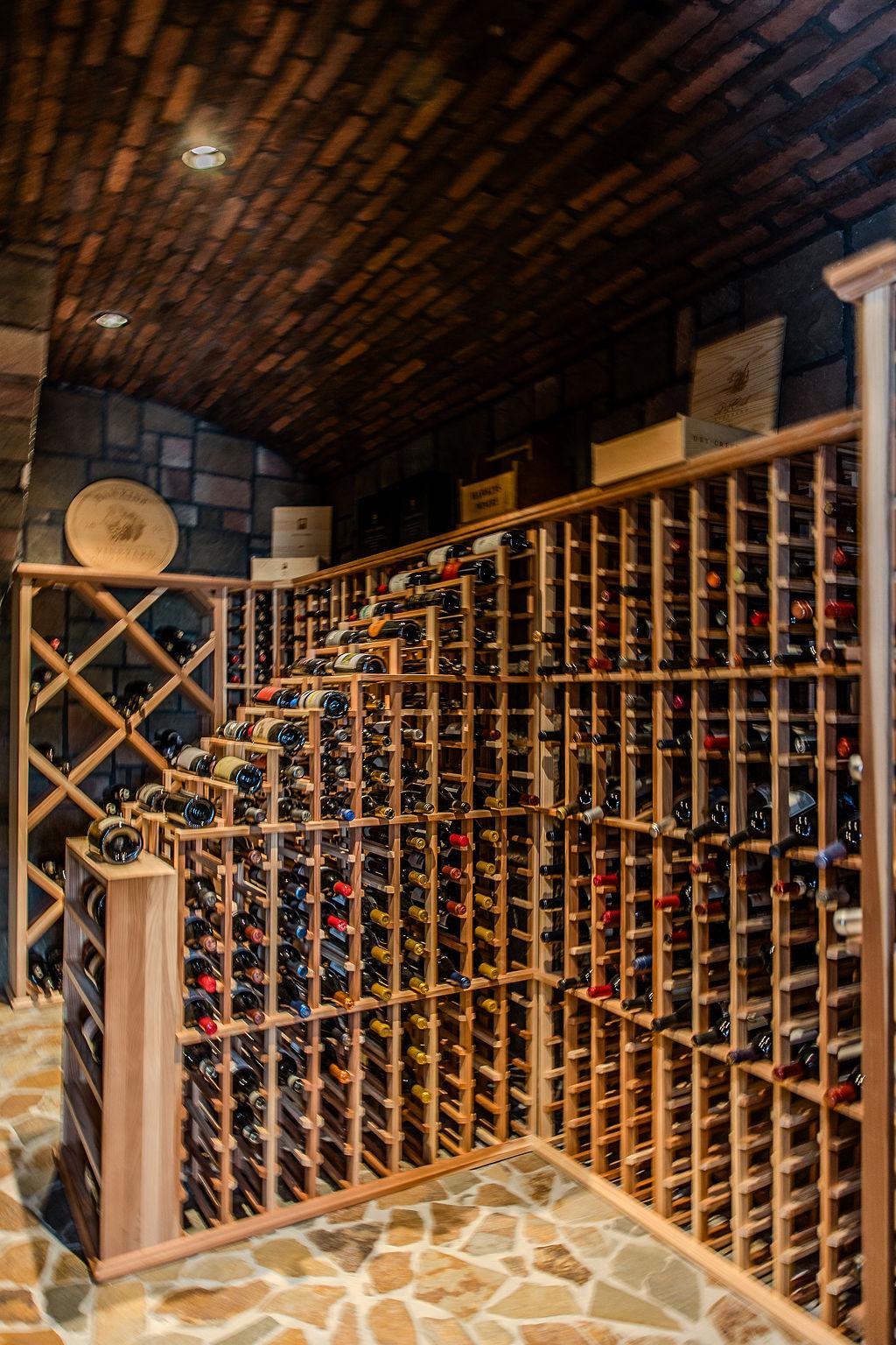 A wine rack with bottles on it

Description automatically generated