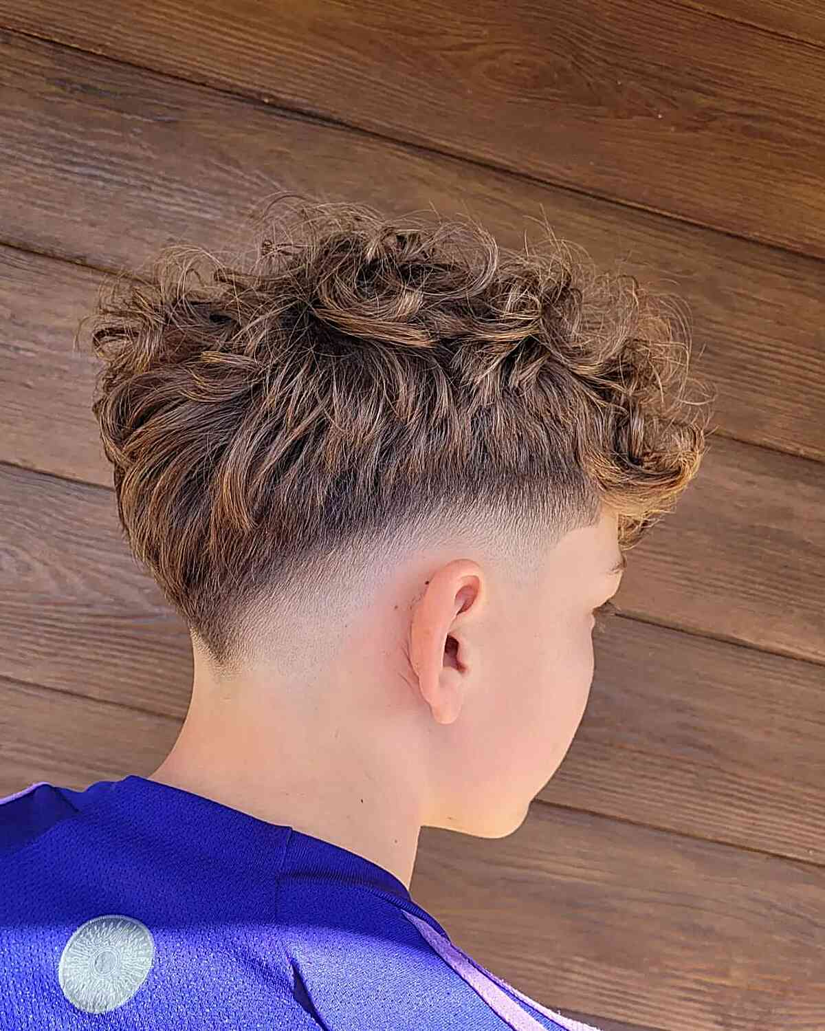Back view of a boy rocking the V- shaped drop fade