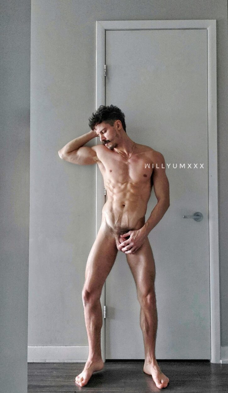 william miguel standing naked against a wall while posing for an iphone mirror selfie
