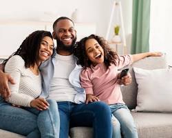 family sitting together on a couch, looking supportive