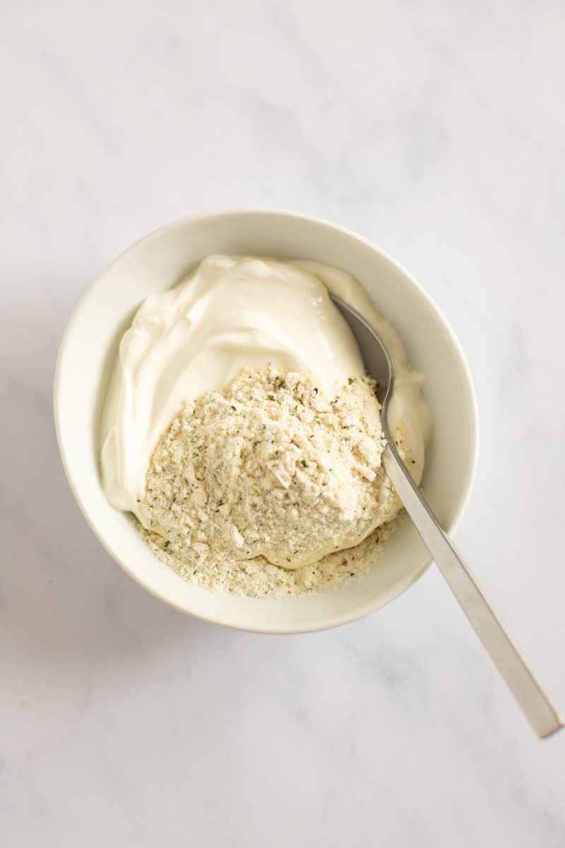 Sour cream and ranch seasoning mixture in a bowl.