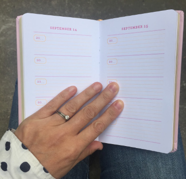 A hand holding a notebook

Description automatically generated