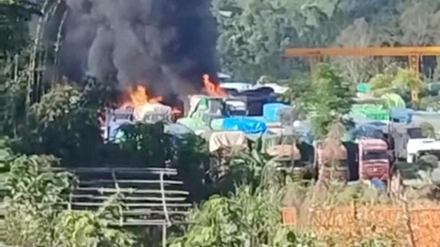 Smoke rises as a convoy of trucks burn near the Myanmar-China border, near Muse, Myanmar, in this screen grab obtained from a social media video released on November 23, 2023.