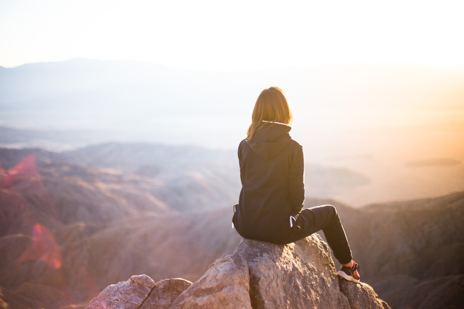 Young women sitting at mountains for mental clarity