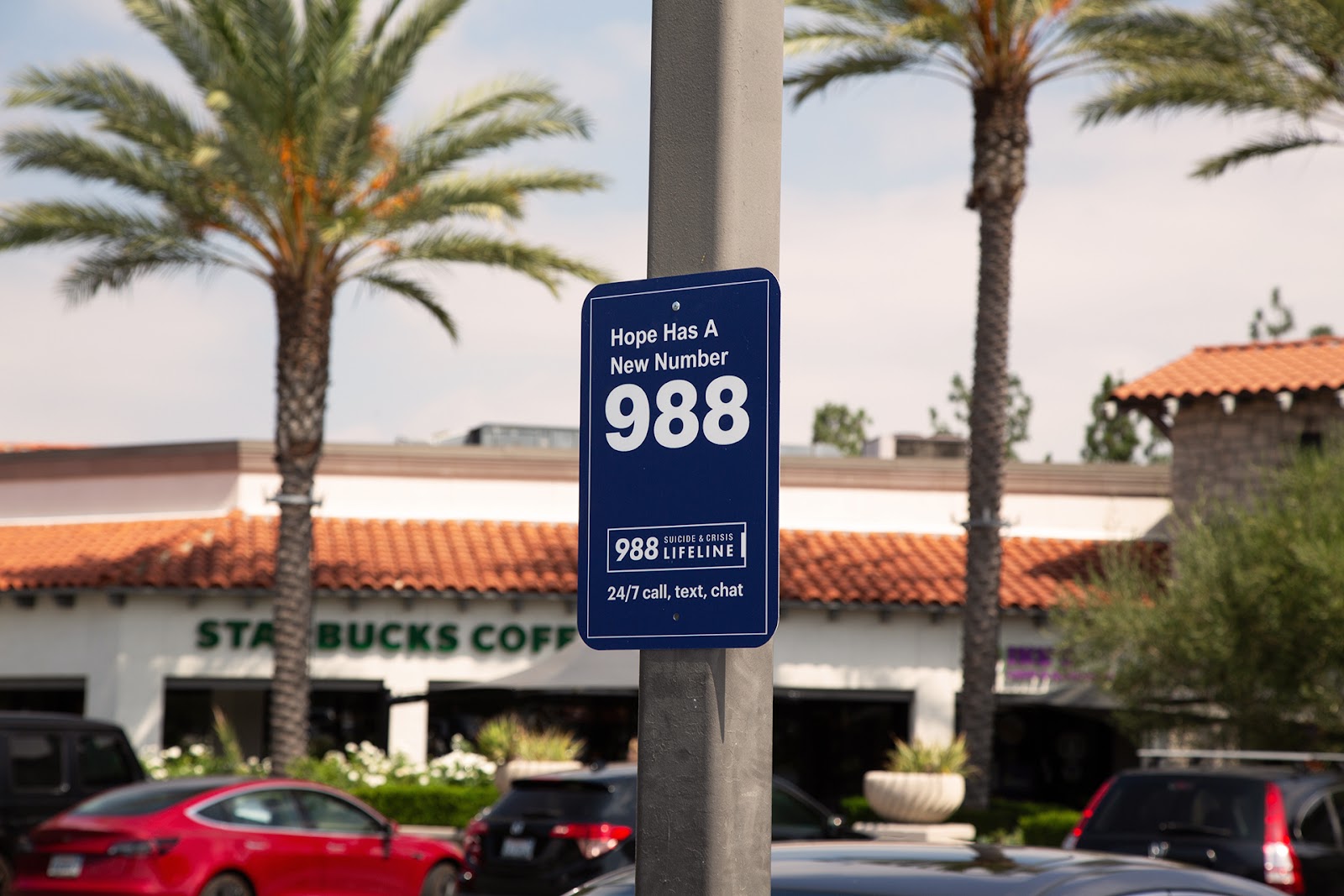 Sign reading "Hope Has A New Number 988 Suicidal and Crisis Lifeline 24/7 call, text, chat"
