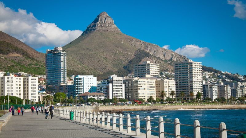 The Sea Point Promenade in Cape Town, with Lion's Head mountain in the background.