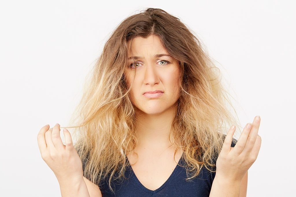 Annoyed women with frizzy hair