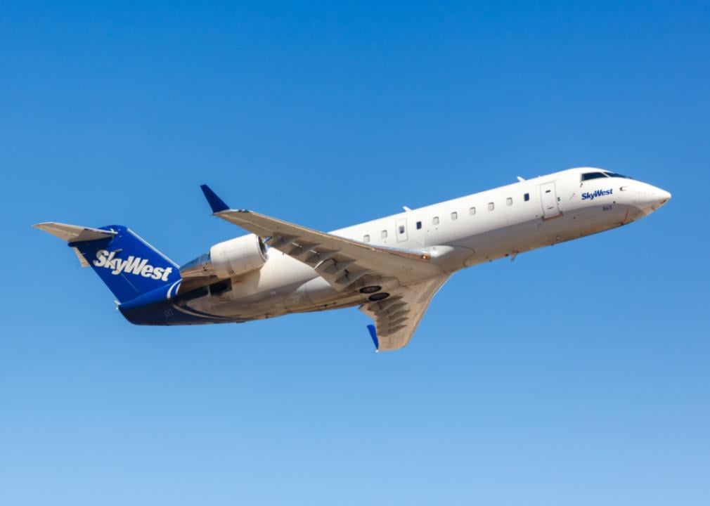 A passenger jet flying through a clear blue sky.