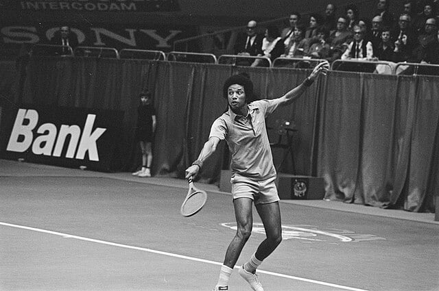 spotcovery-Arthur Ashe playing tennis-discover-black-tennis-players-who-have-featured-in-the-australian-open