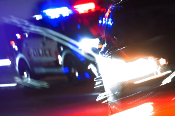 Hot Pursuit Police Traffic Chase at Night Hot Pursuit Police Traffic Chase at Night. Police Cruiser Next to Running Out DUI Driver Conceptual Photo with Motion Blurs. Police Enforcement Theme. dui stock pictures, royalty-free photos & images