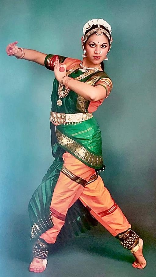 A person dancing in traditional indian attire

Description automatically generated