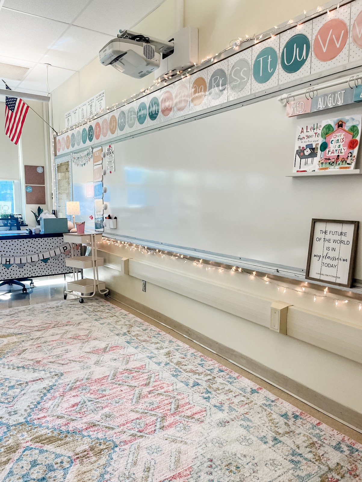 This image shows a cozy classroom with a rug, twinkle lights, and calm-colored classroom decor. 