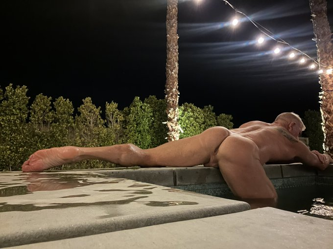 Matthew Figata posing naked on the edge of a swimming pool at night revealing his hot toned shaved ass