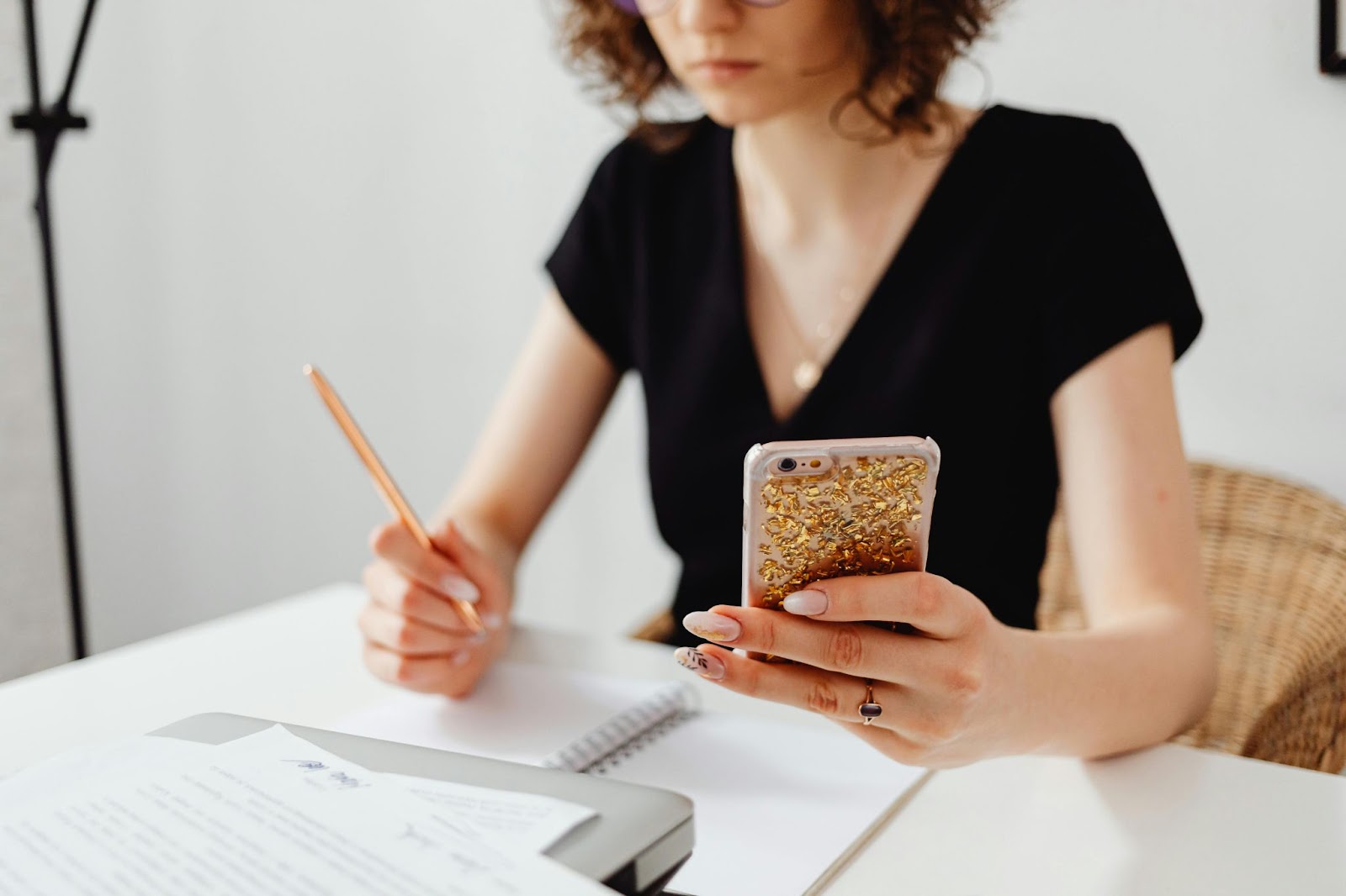 A woman reviewing documents to avoid becoming a victim of check fraud a felony