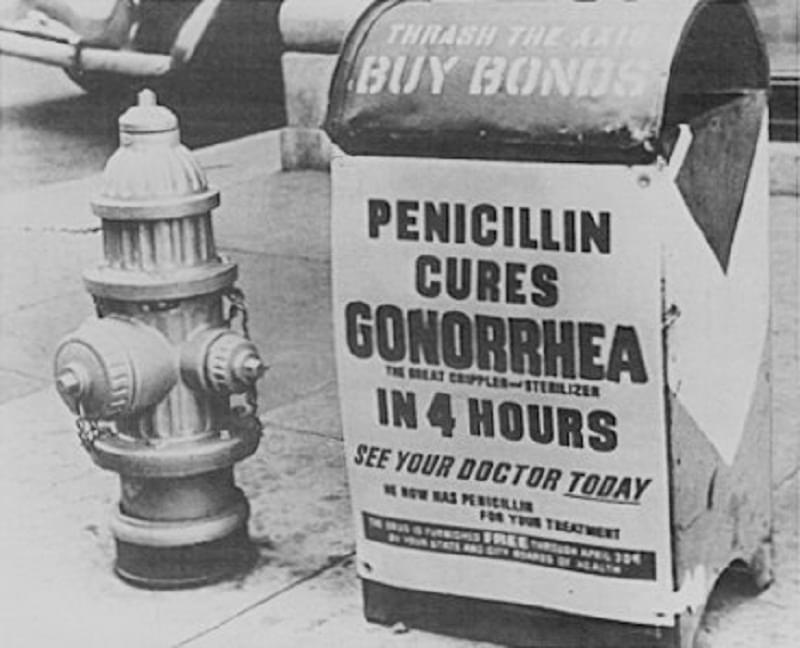 A poster attached to a curbside mailbox offering advice to World War II servicemen: Penicillin cures gonorrhea in 4 hours, 1944