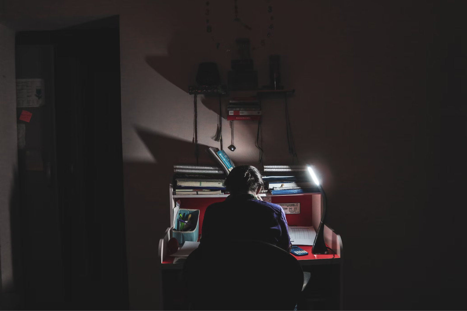 {Person studying at a desk late at night - Photo by RAMSHA ASAD on Unsplash}