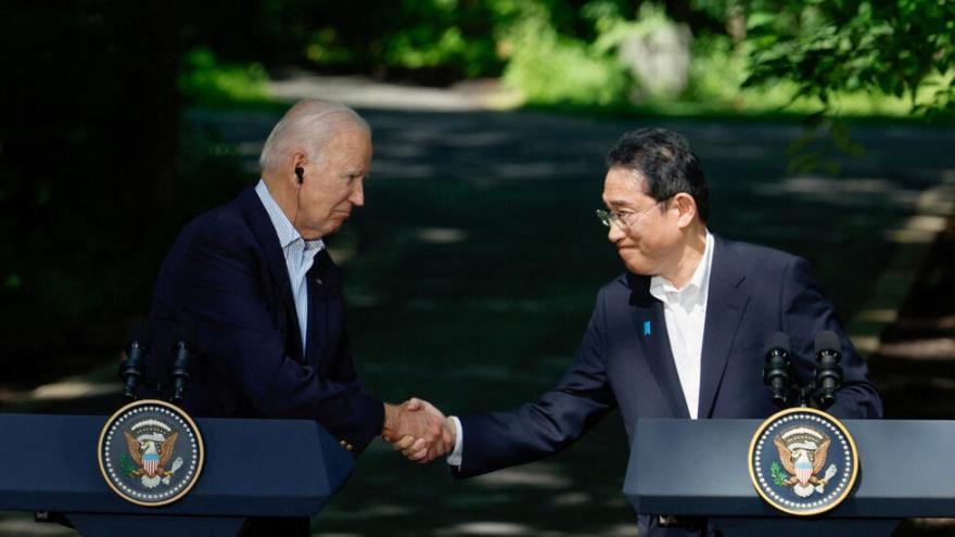 Japanese Prime Minister Fumio Kishida shakes hands with U.S. President Joe Biden during a joint press conference with South Korean President Yoon Suk Yeol (not pictured) during the trilateral summit