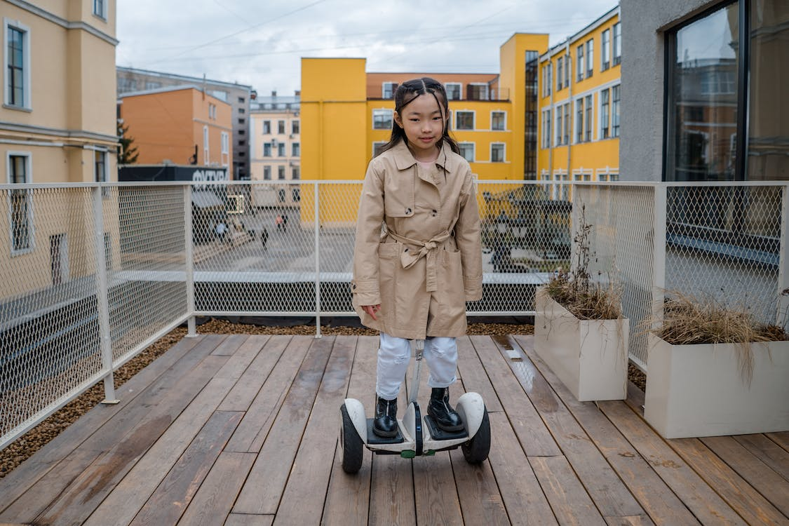 A young girl enjoying riding on a hoverboard