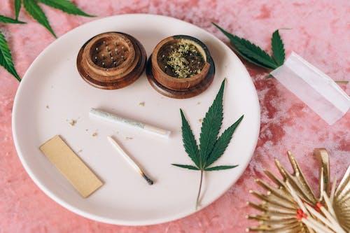Free Marijuana Joint and Leaves on the Plate Stock Photo