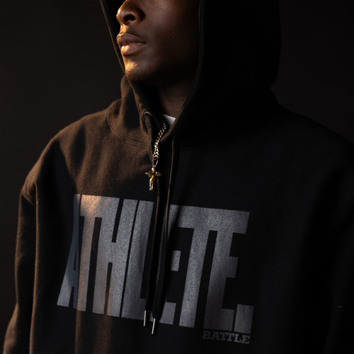 male athlete wearing a black ATHLETE hoodie by Battle Sports