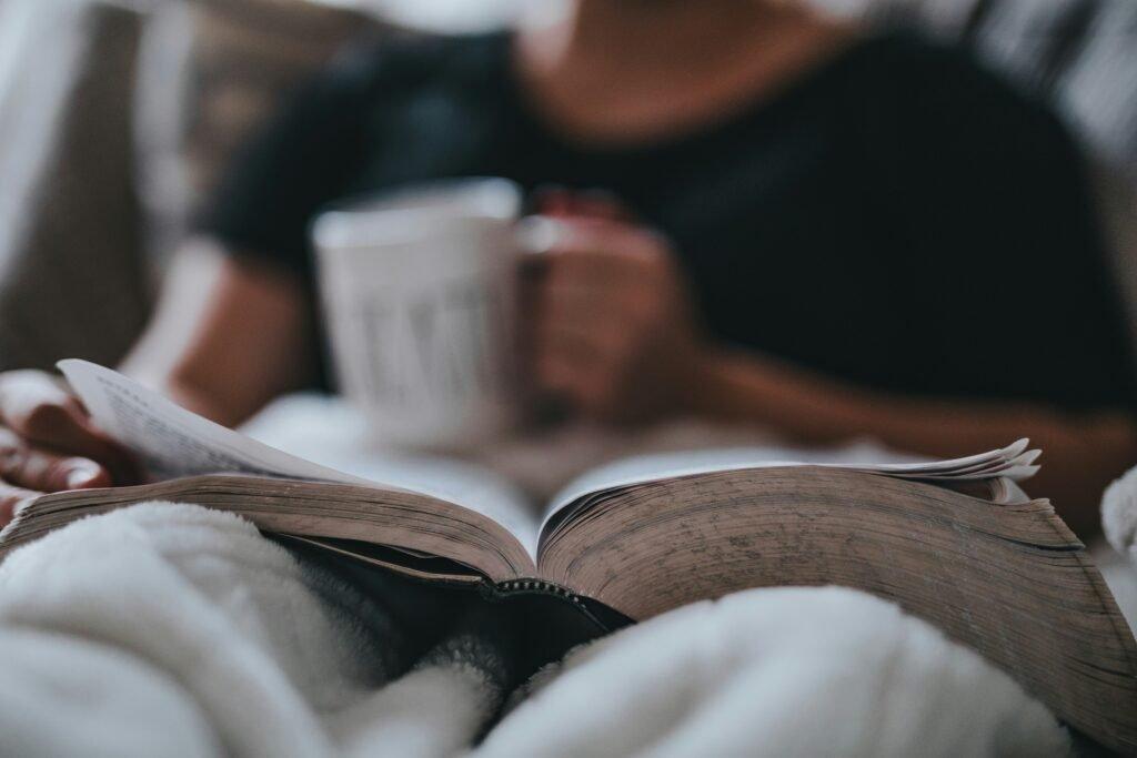 person in his bed reading a book - Exam Preparation Tips