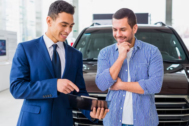 Car dealer talking to client