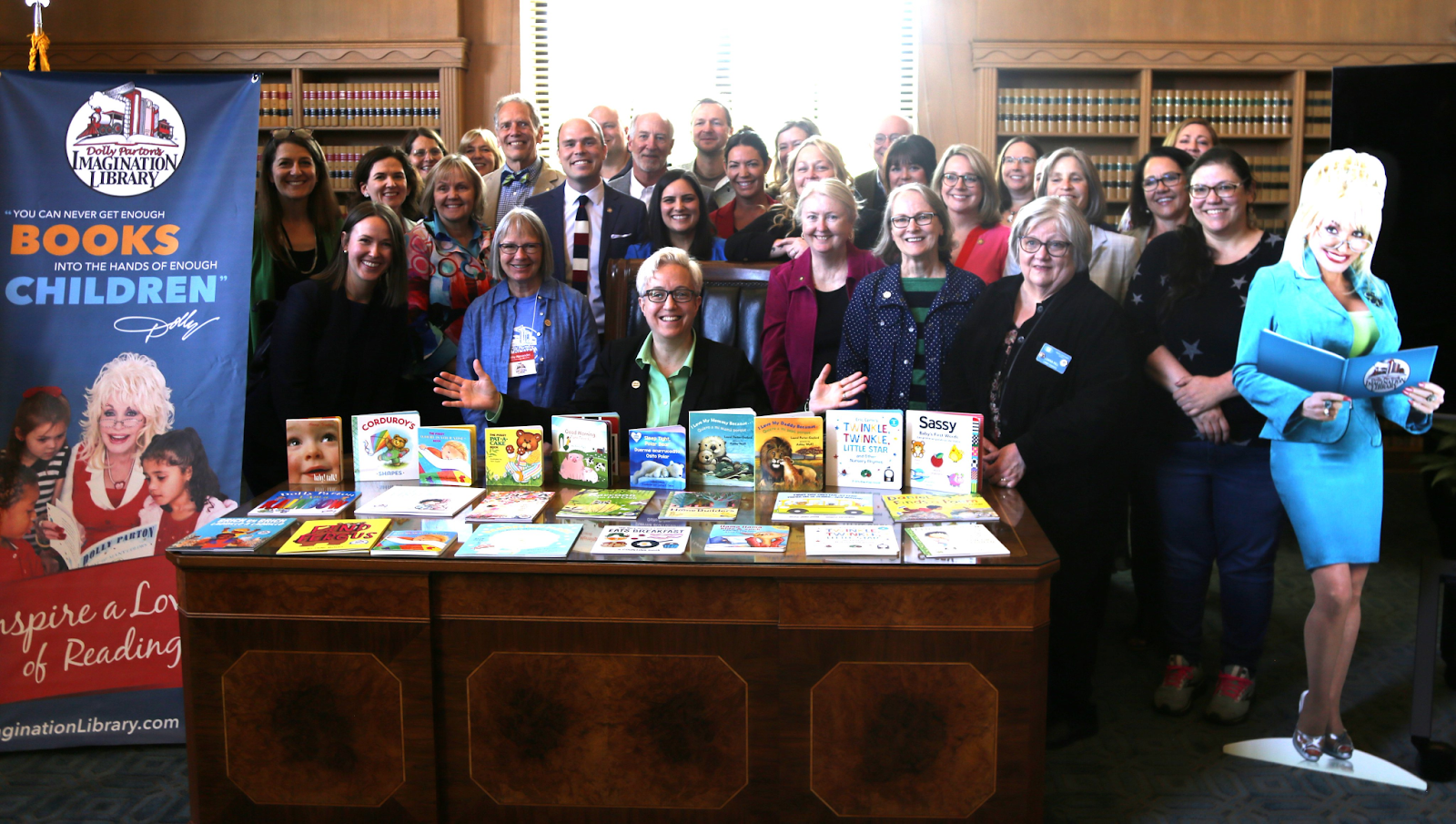 Tina poses with books in celebration of Dolly's Library!