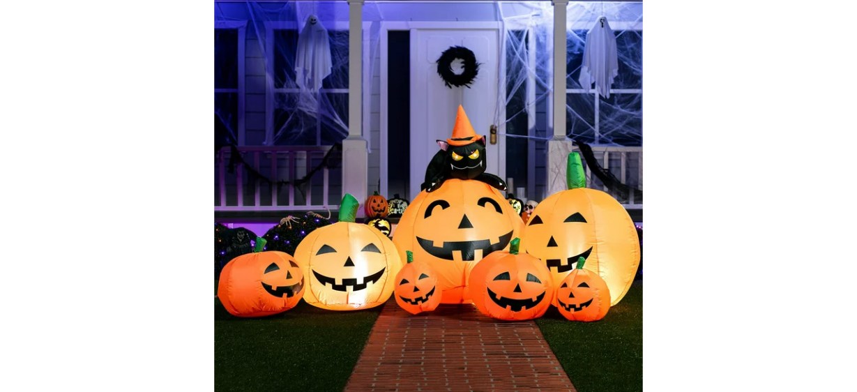 Halloween inflatable pumpkins in front yard at night